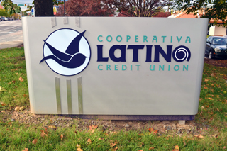 Beautiful sign marks the site of the Latino Community Credit Union. Photo by Liz Hannah