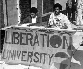 Howard Fuller worked throughout North Carolina on poverty issues and was the leader of the group that founded MXLU. He is pictured (right) registering students for classes in 1969. Photo courtesy of Durham Herald Sun 