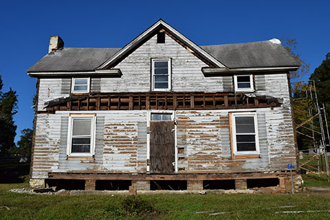The house in 2015. Renovation work began by removing all of the non-historic elements like the aluminum siding and rebuilt front porch.