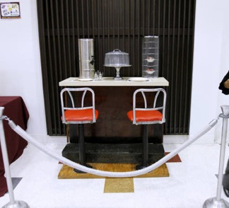 A portion of the original lunch counter, its seats, and pie rack preserved in the James E. Shepard Memorial Library at North Carolina Central University.  Photo by Takaaki Iwabu.